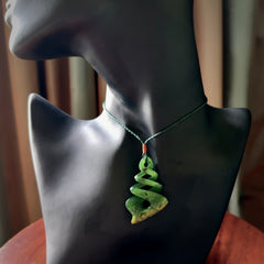 This is a striking, medium sized, twist pendant carved in New Zealand jade by Shaun Gardiner. Hand made Jade twist with adjustable green cord.