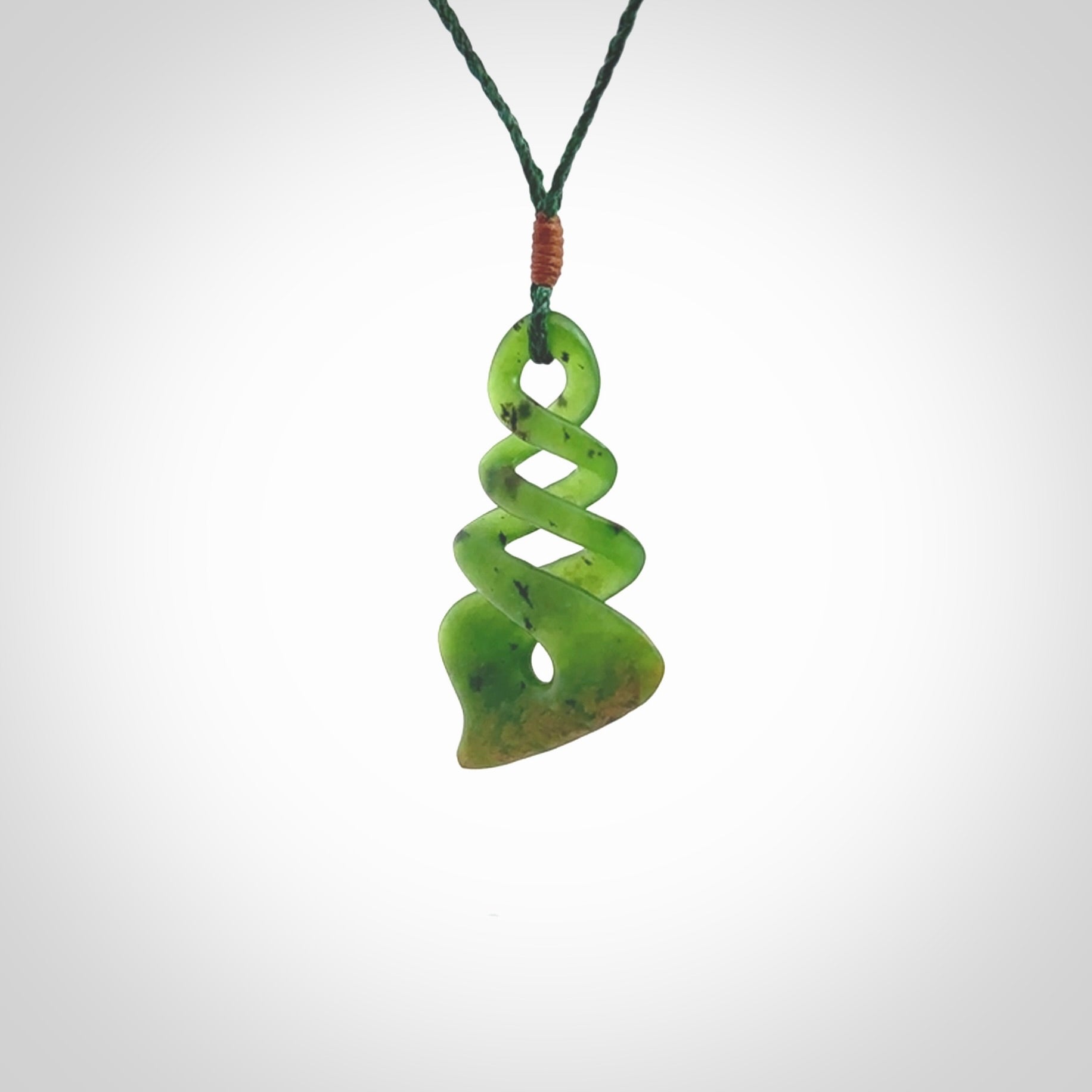 This is a striking, medium sized, twist pendant carved in New Zealand jade by Shaun Gardiner. Hand made Jade twist with adjustable green cord.