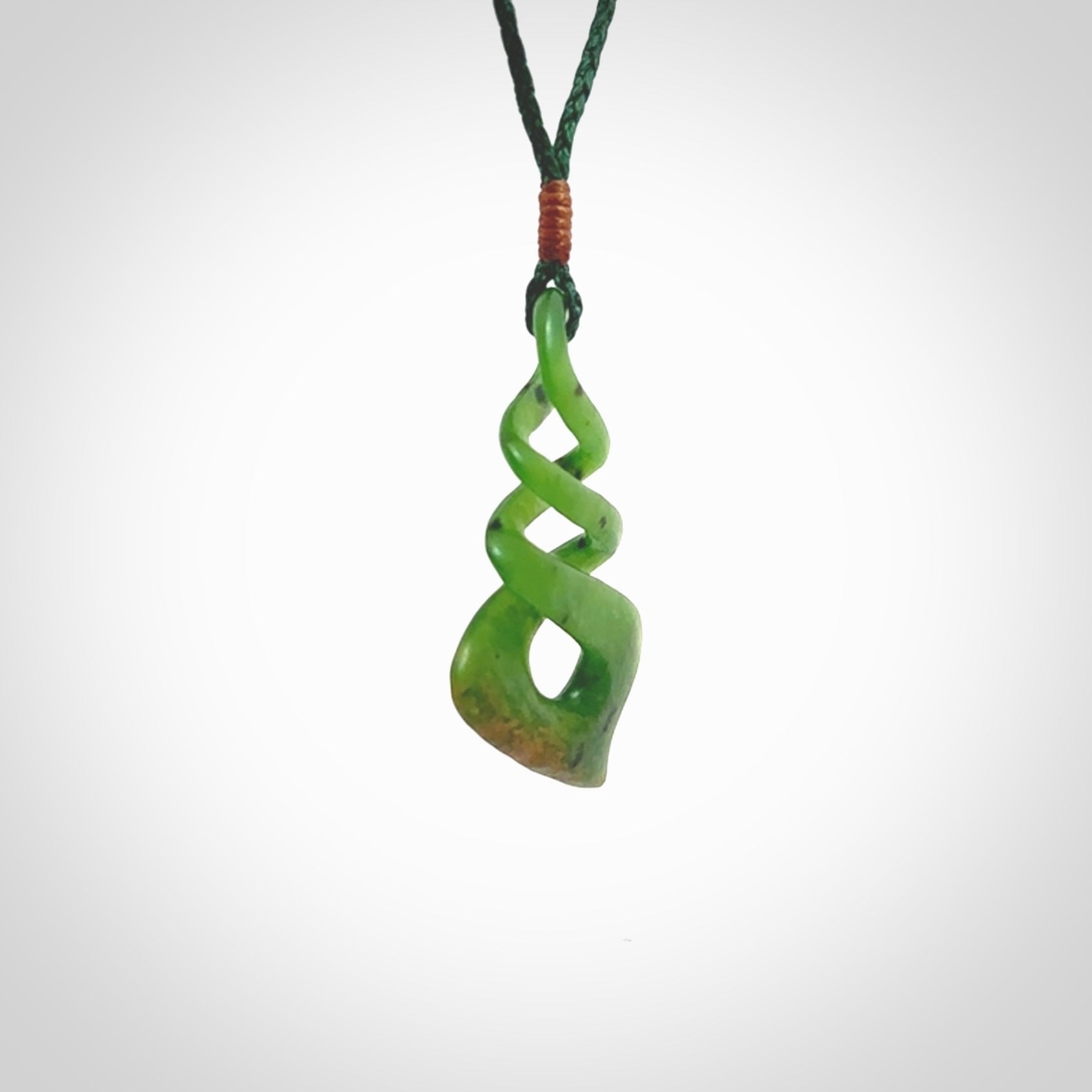 This is a striking, medium sized, twist pendant carved in New Zealand jade by Shaun Gardiner. Hand made Jade twist with adjustable green cord.