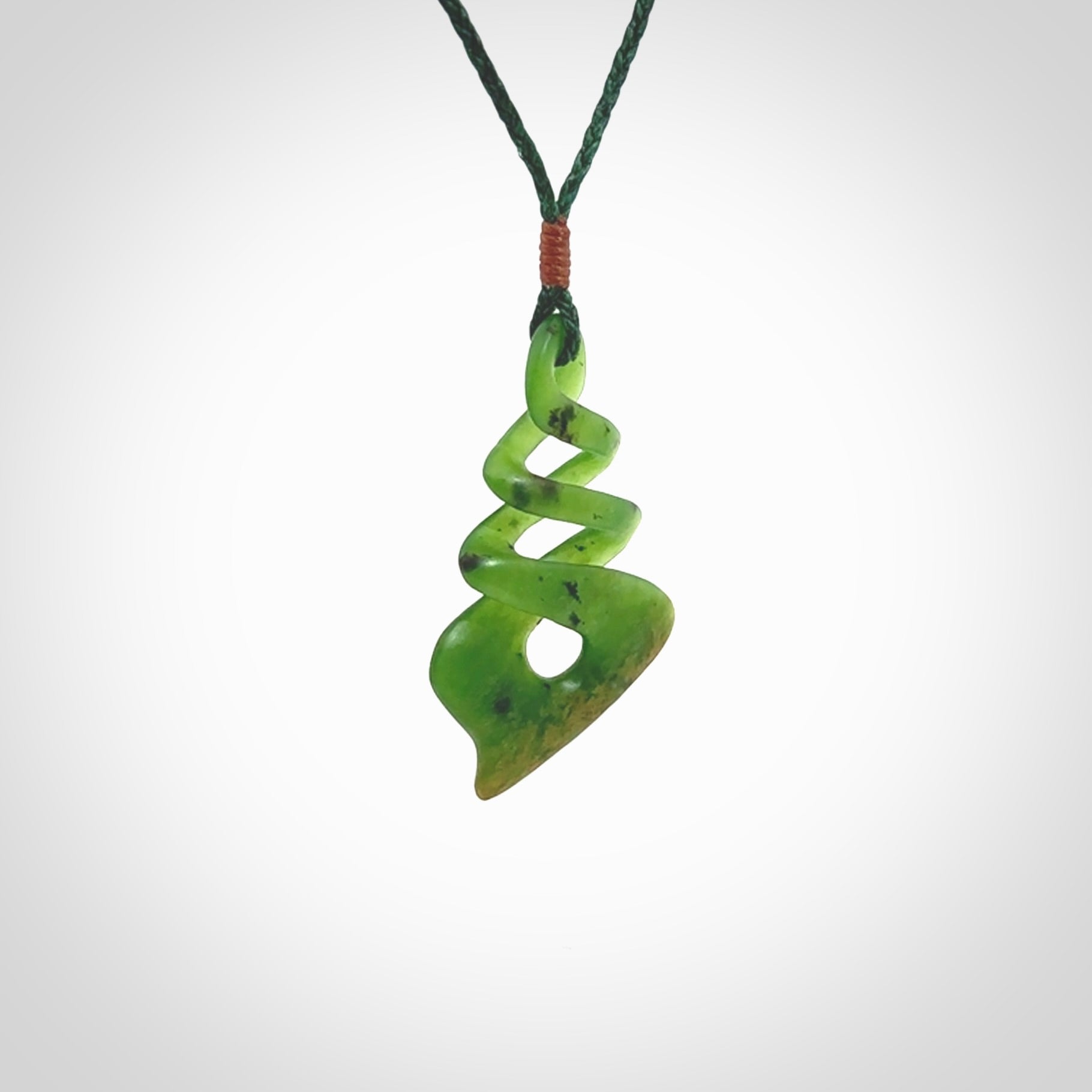 This is a striking, medium sized, twist pendant carved in New Zealand jade by Shaun Gardiner. Hand made Jade twist with adjustable green cord.