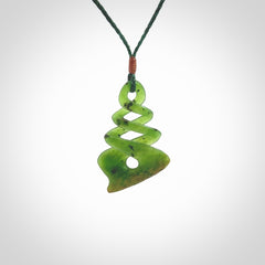 This is a striking, medium sized, twist pendant carved in New Zealand jade by Shaun Gardiner. Hand made Jade twist with adjustable green cord.