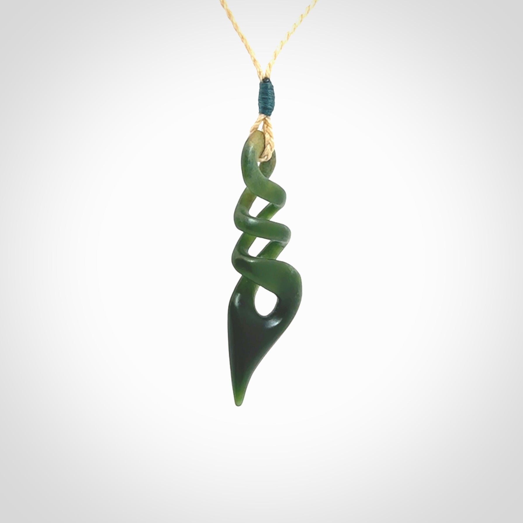 This is a striking, medium sized, twist pendant carved in New Zealand jade by Shaun Gardiner. Hand made Jade twist with adjustable oat coloured cord.