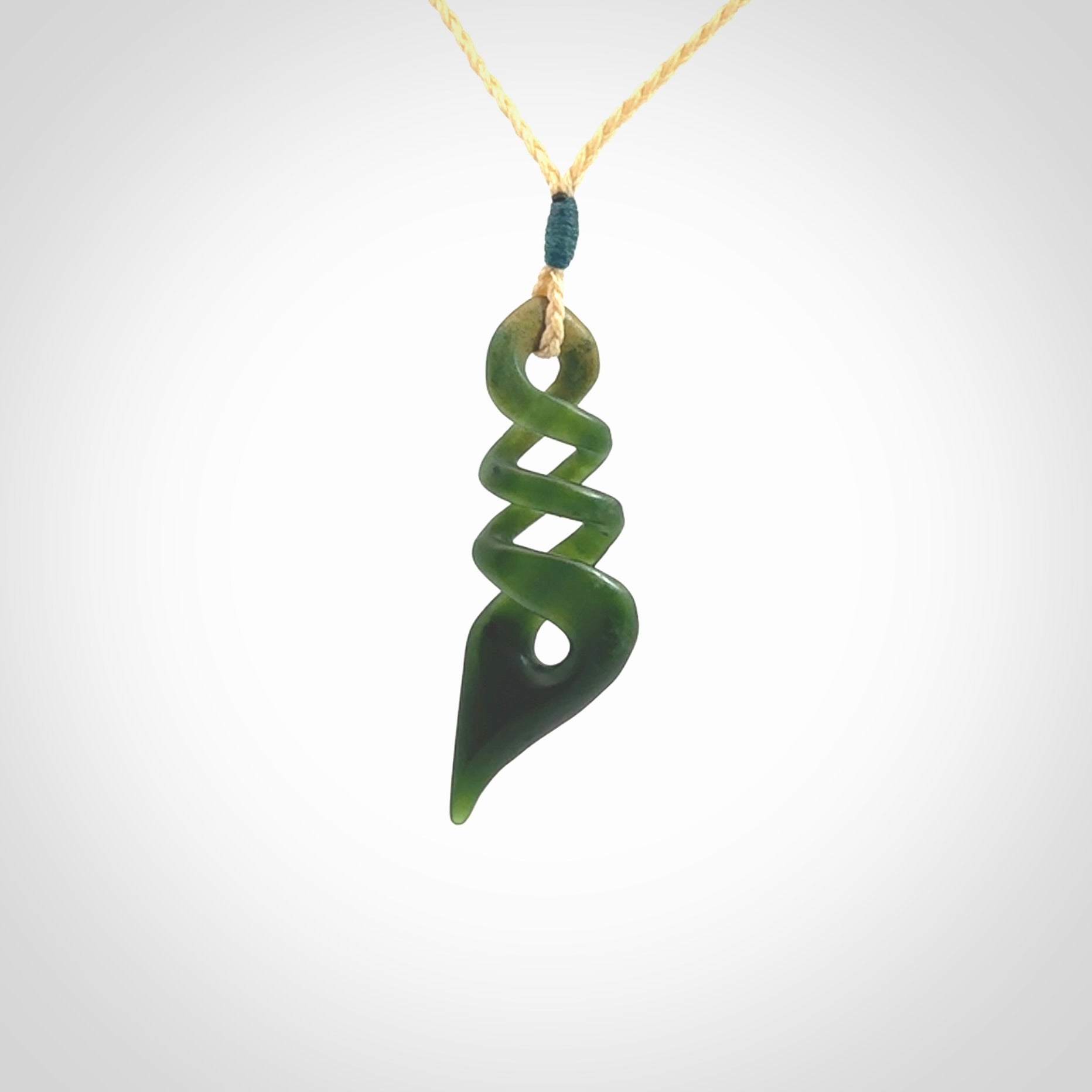 This is a striking, medium sized, twist pendant carved in New Zealand jade by Shaun Gardiner. Hand made Jade twist with adjustable oat coloured cord.