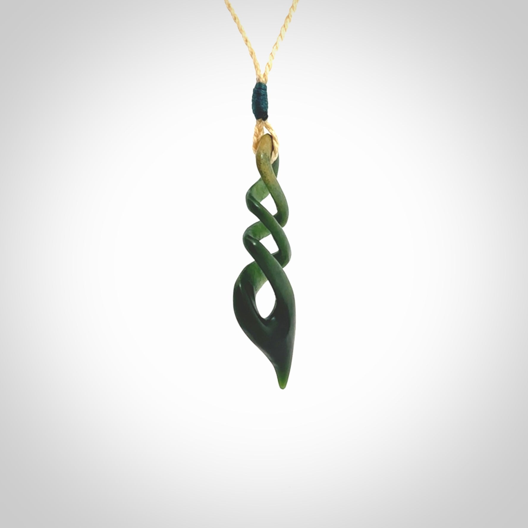 This is a striking, medium sized, twist pendant carved in New Zealand jade by Shaun Gardiner. Hand made Jade twist with adjustable oat coloured cord.