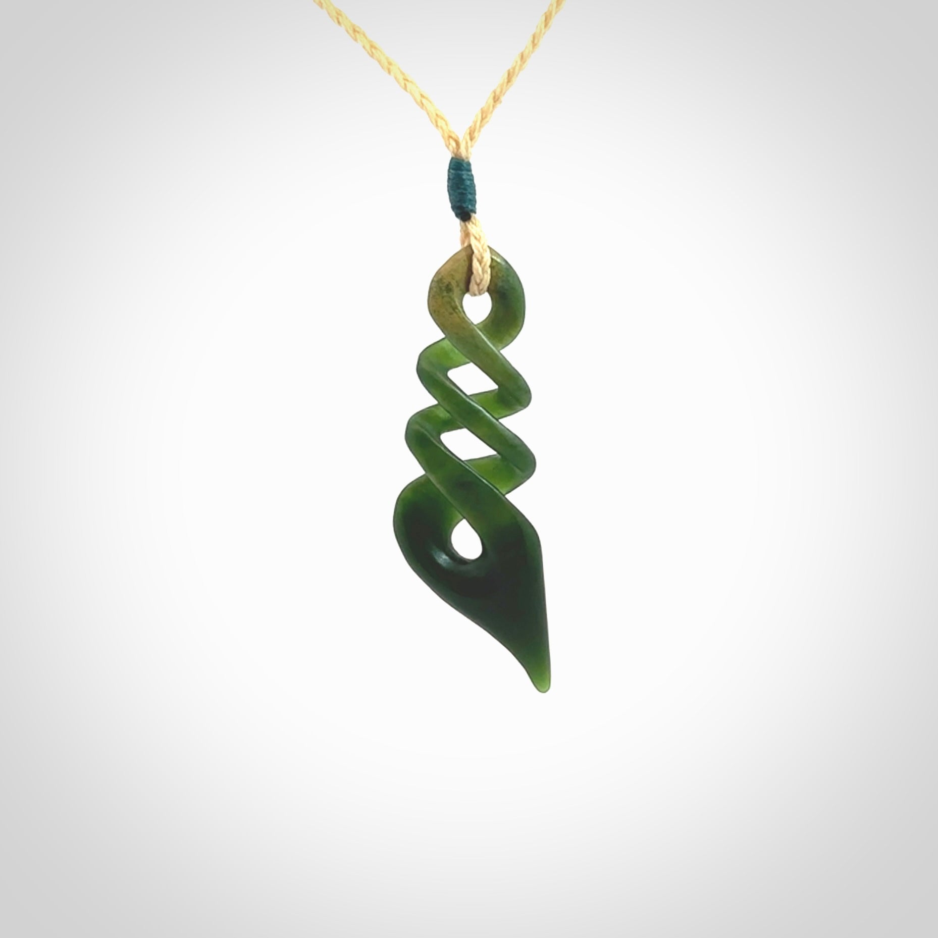 This is a striking, medium sized, twist pendant carved in New Zealand jade by Shaun Gardiner. Hand made Jade twist with adjustable oat coloured cord.