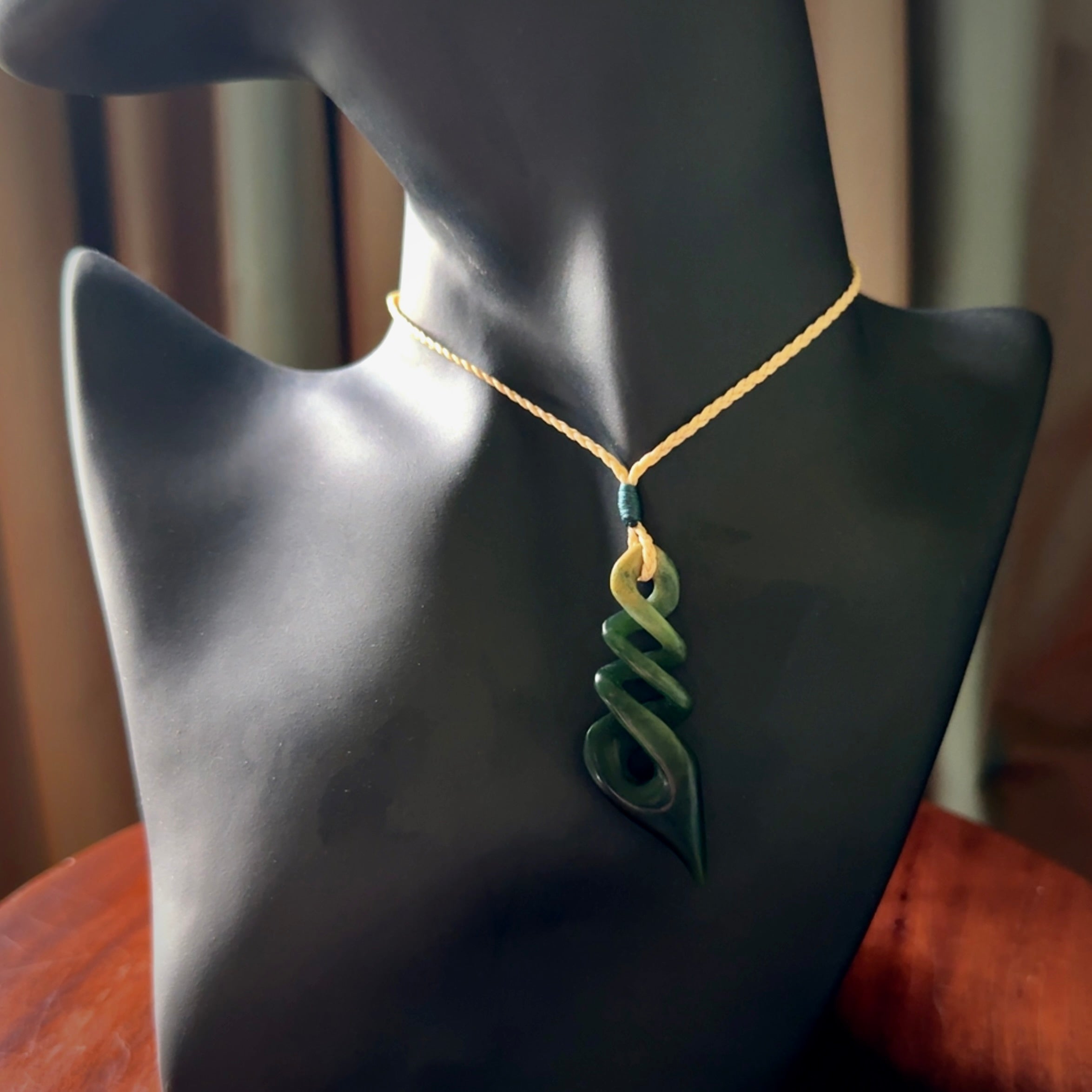 This is a striking, medium sized, twist pendant carved in New Zealand jade by Shaun Gardiner. Hand made Jade twist with adjustable oat coloured cord.