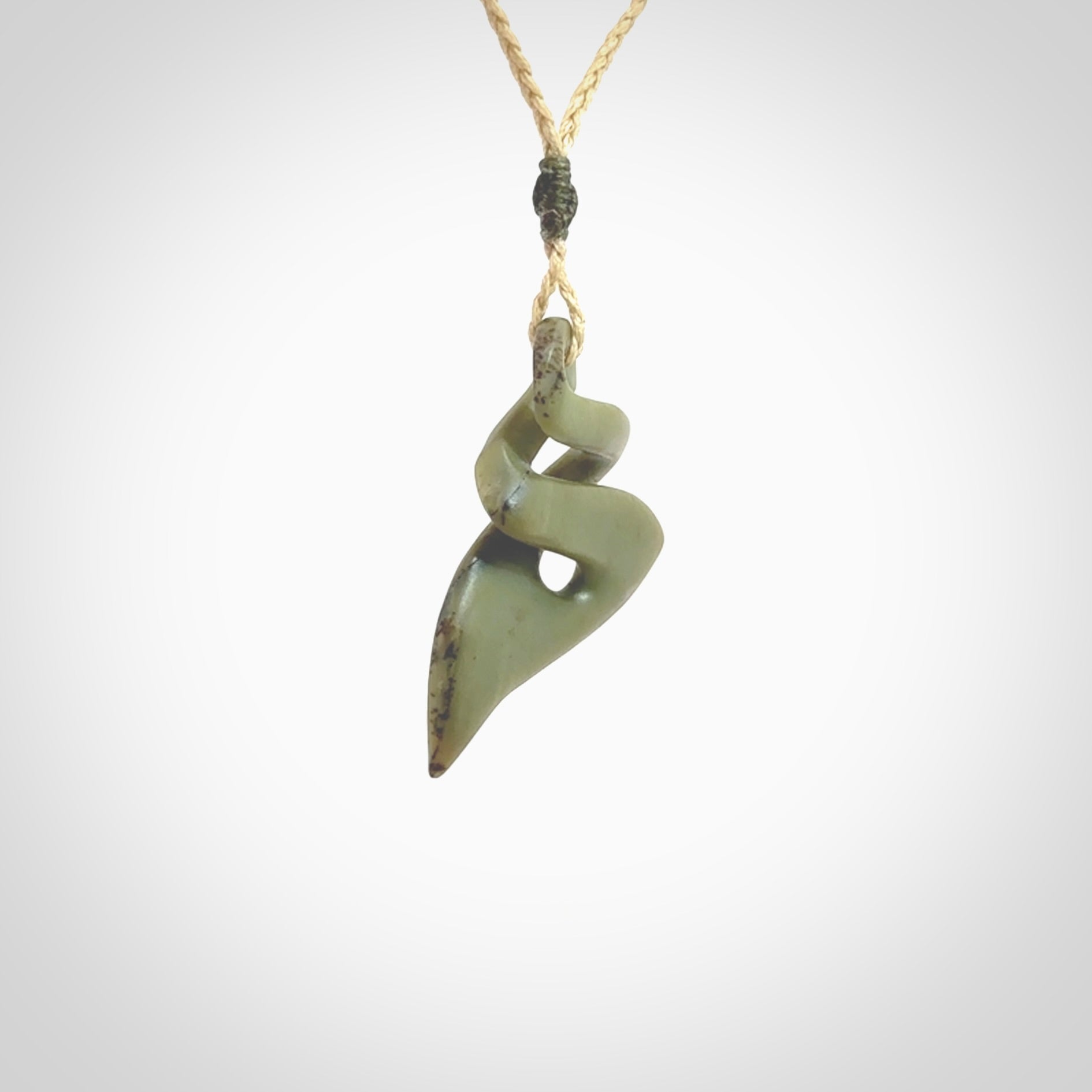 Hand carved New Zealand jade twist pendant. Carved in New Zealand by NZ Pacific. Hand made Jade twist with adjustable oat coloured cord by Shaun Gardiner.