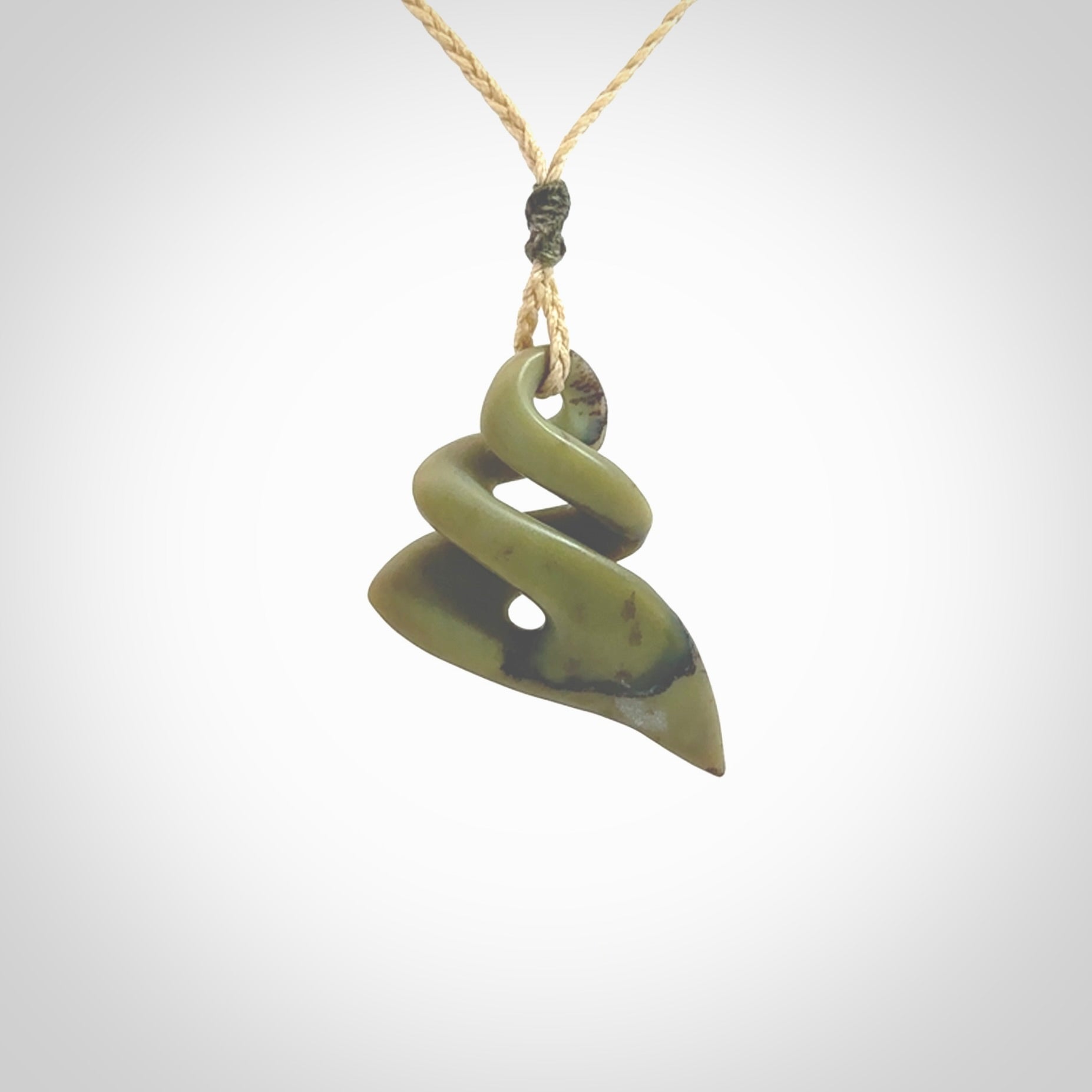 Hand carved New Zealand jade twist pendant. Carved in New Zealand by NZ Pacific. Hand made Jade twist with adjustable oat coloured cord by Shaun Gardiner.