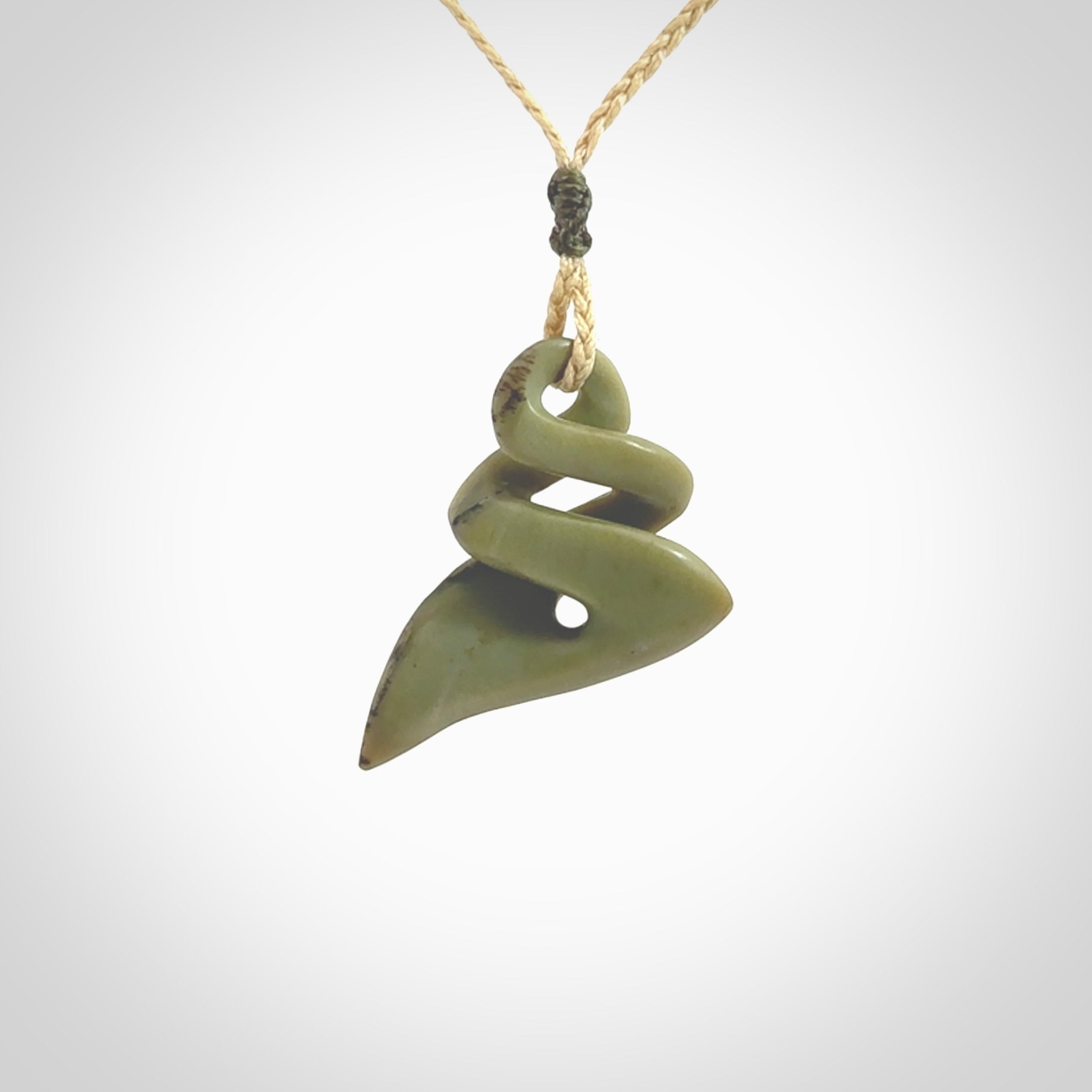 Hand carved New Zealand jade twist pendant. Carved in New Zealand by NZ Pacific. Hand made Jade twist with adjustable oat coloured cord by Shaun Gardiner.