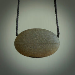 Greywacke stone pendant with Aotea Stone insert. Hand carved by Rhys Hall for NZ Pacific. Handmade contemporary jewellery for sale online.