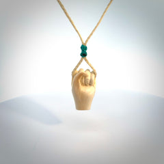 Hand carved pendant symbolising strength and hope - Shown worn. Carved by NZ Pacific from ancient woolly mammoth tusk. Unique jewellery for sale online.