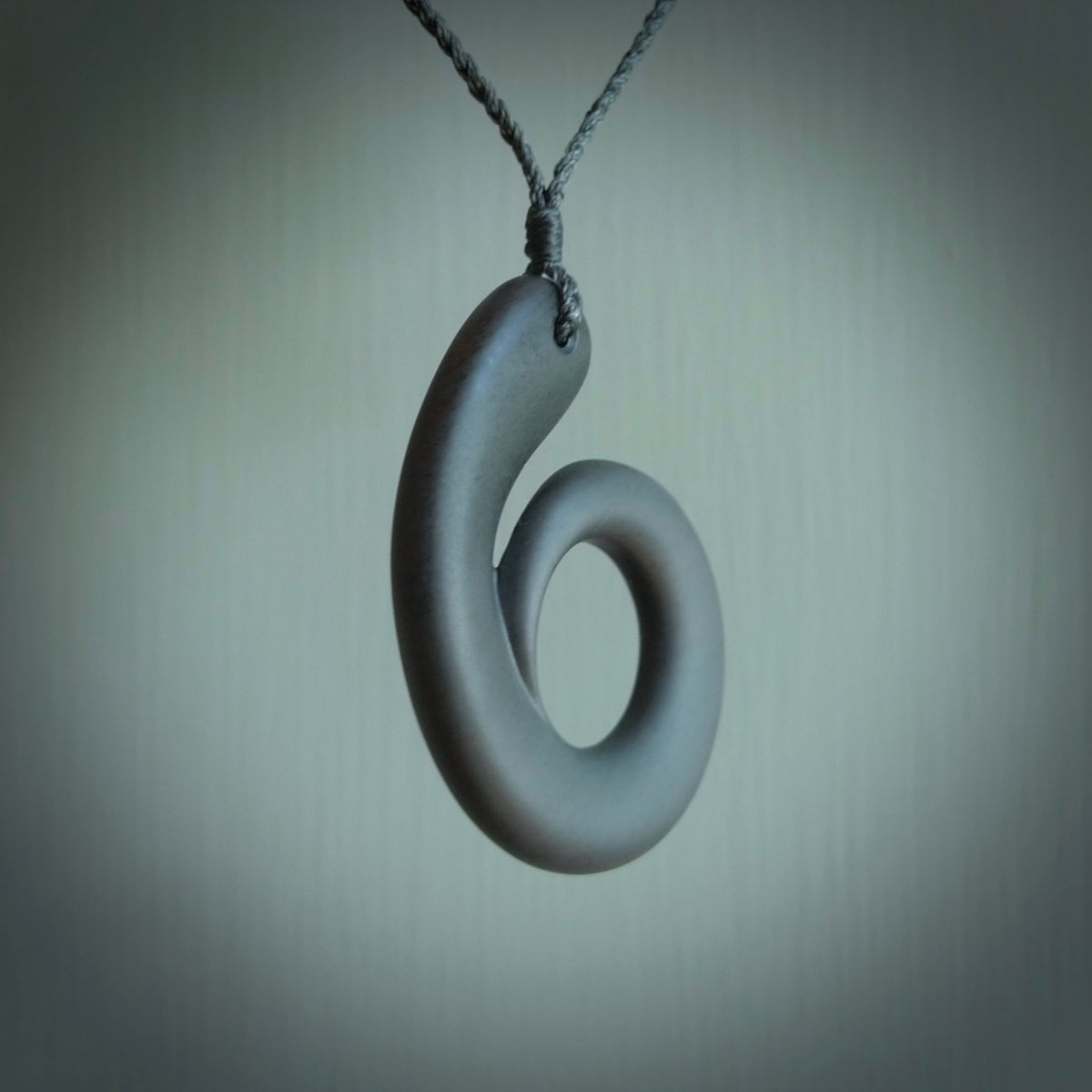 Argillite stone pendant shaped as a tusk. Hand carved by Rhys Hall for NZ Pacific. Handmade contemporary jewellery for sale online.