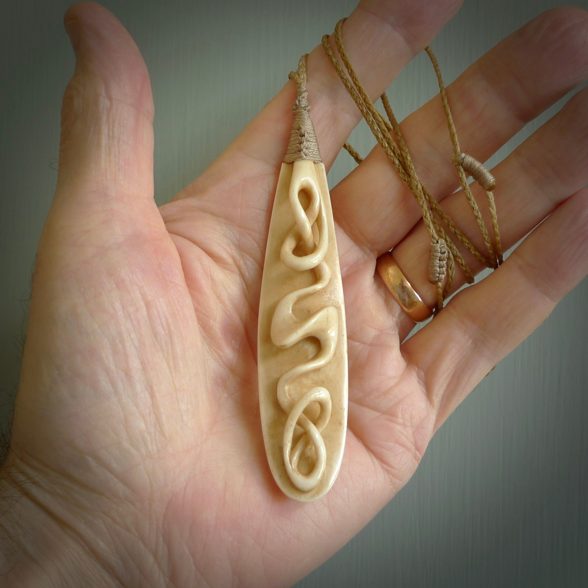 A handcarved masterpiece. A complex twist pendant carved from bone by Yuri Terenyi for NZ Pacific. This is a true piece of wearable art which is collectible. A one-off masterpiece and quite unique. Delivered with Express Courier and gift wrapped in a woven kete pouch.