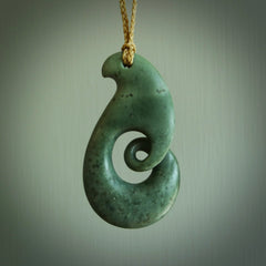 A hand carved koru pendant from New Zealand Jade. The cord is a tan colour and is adjustable. A large hand made Koru necklace by New Zealand artist Kerry Thompson.