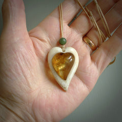 This is a hand carved whalebone heart with amber pendant. It is made from whale bone. This is a medium sized necklace and is a very unique, one only, pendant that is a collectors piece. Hand carved by New Zealand artist, Sami.