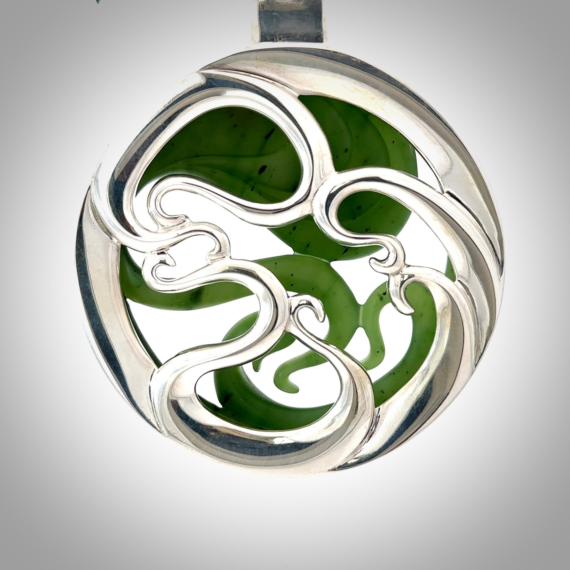 A hand carved New Zealand Jade and Sterling Silver Octopus pendant with Opal eye. Hand made by New Zealand artist Kerry Thompson.