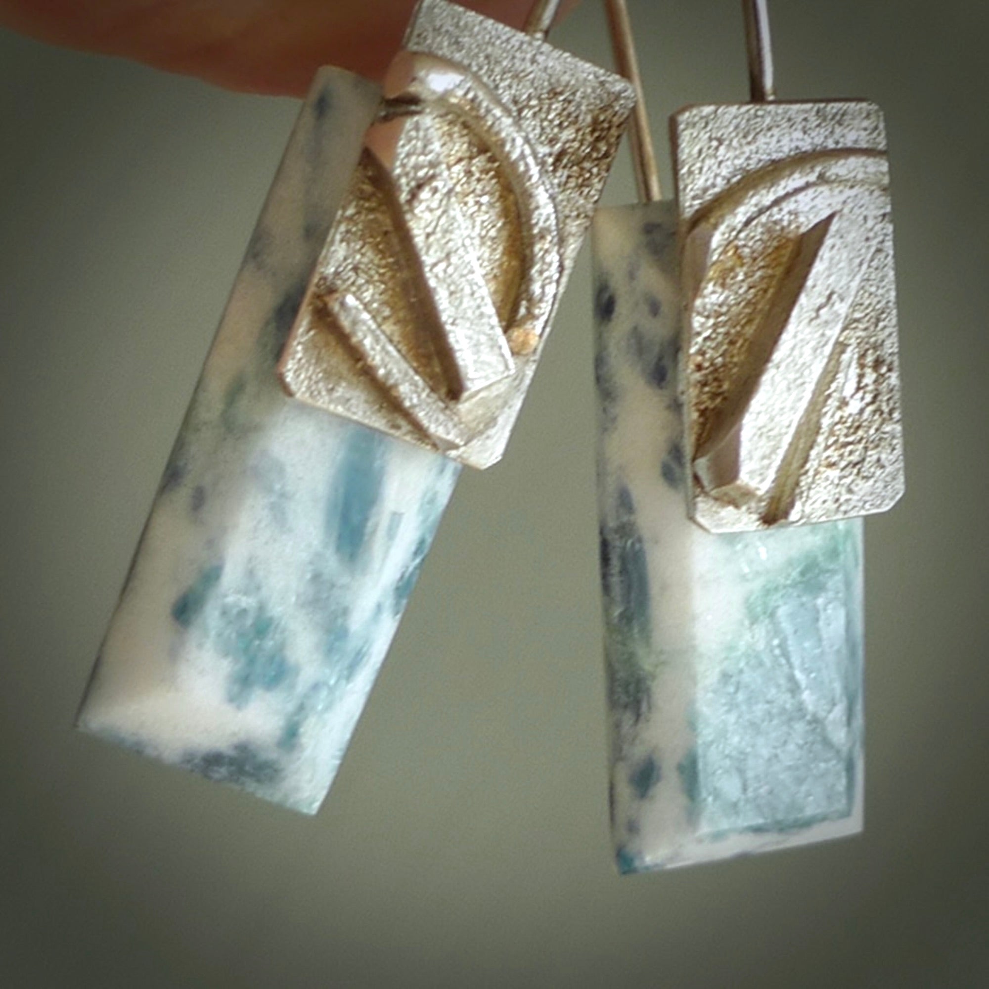 These are a pair of beautiful Aotea Stone and sterling silver earrings. It is carved from Aotea Stone from New Zealand. It is a light blue and white colour with sterling silver. Hand made here in New Zealand by Ana Krakosky.