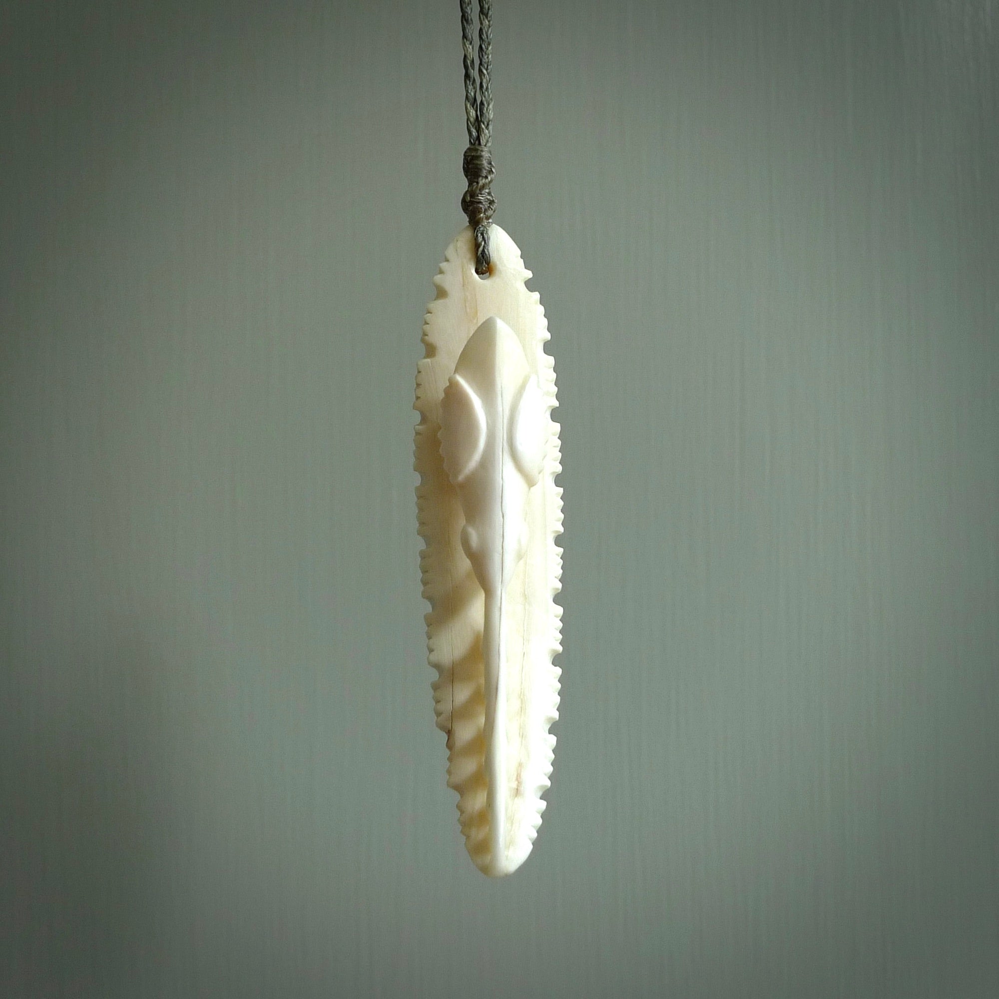 This is a hand carved bone contemporary warthog tusk pendant. Yuri Terenyi has carved this from warthog tusk. It is a delightful, large and artistic piece of jewellery. One only necklace.