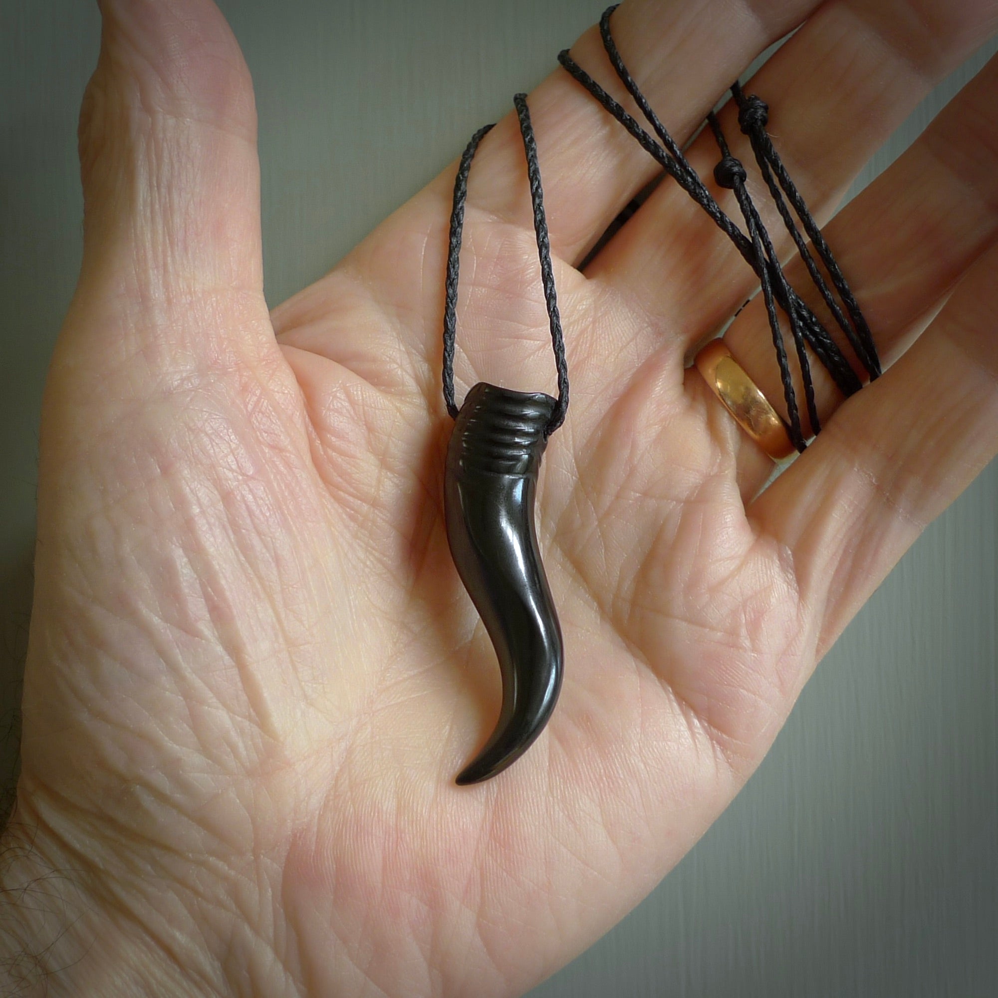 Black jade Italian Horn pendant. Handmade jade jewellery made by NZ Pacific and for sale online. Black Jade Goat Horn pendant worn for protection over evil eye, bad luck and promotes fertility. Ancient symbolic necklace hand made in Australian Black Jade.