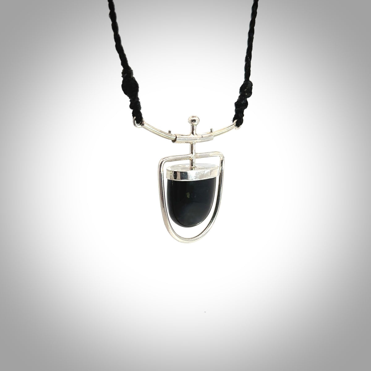 Hand crafted contemporary black jade and sterling silver drop necklace. This necklace is provided with a fern green cord and silver clasp. Contemporary black jade drop necklace with sterling silver.