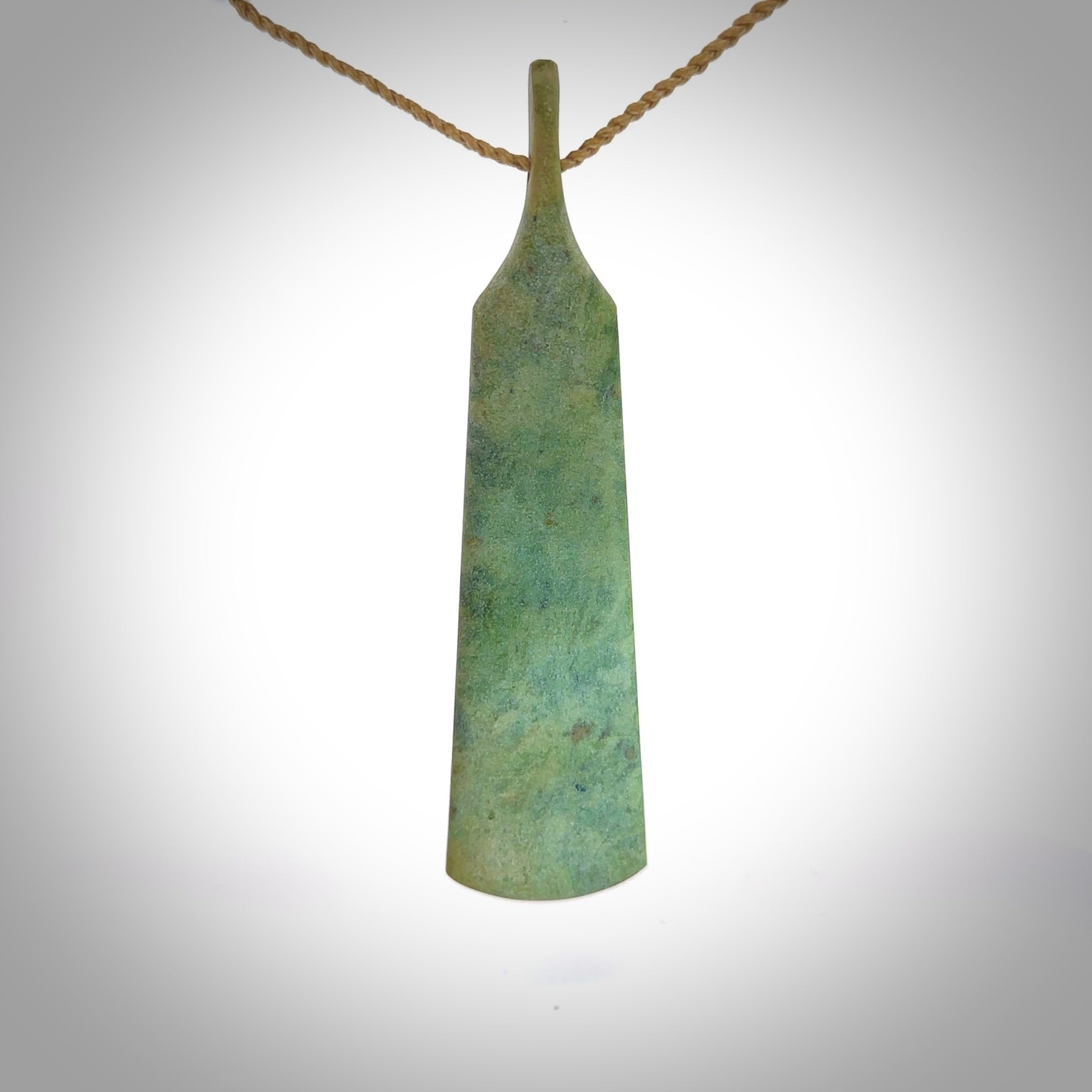 A hand carved large New Zealand Jade feather necklace. The cord is a tan colour and is a fixed length. A large sized hand made Jade feather necklace by New Zealand artist Kerry Thompson. One off work of art to wear.