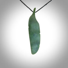 A hand carved large New Zealand Jade feather necklace. The cord is a black colour and is a fixed length. A large sized hand made Jade feather necklace by New Zealand artist Kerry Thompson. One off work of art to wear.