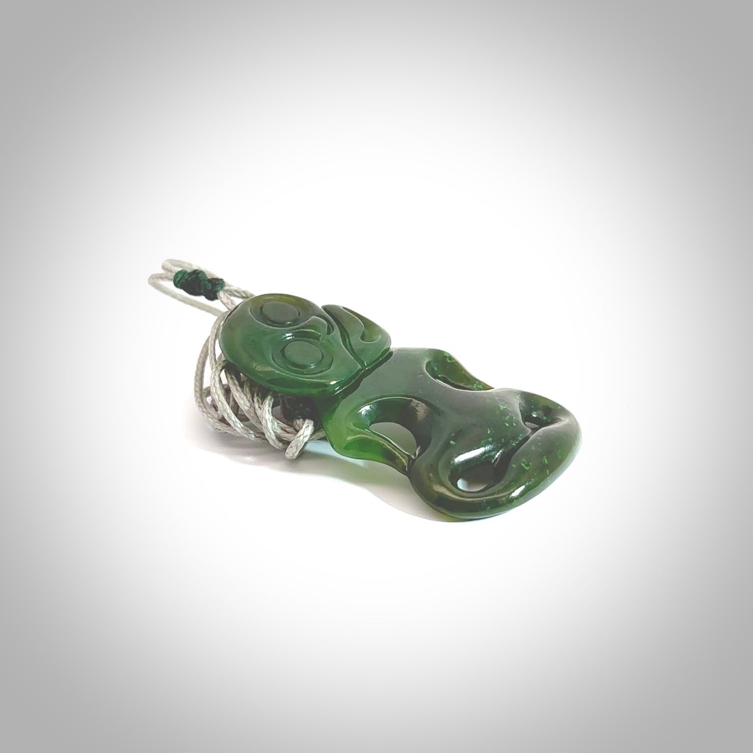 This pendant is a small jade tiki pendant. The carving shows wonderful detail on the front while the back is beautifully rounded. These are carved in Columbian Jade. The cord is adjustable in length. Provided in a woven kete pouch and shipped worldwide.