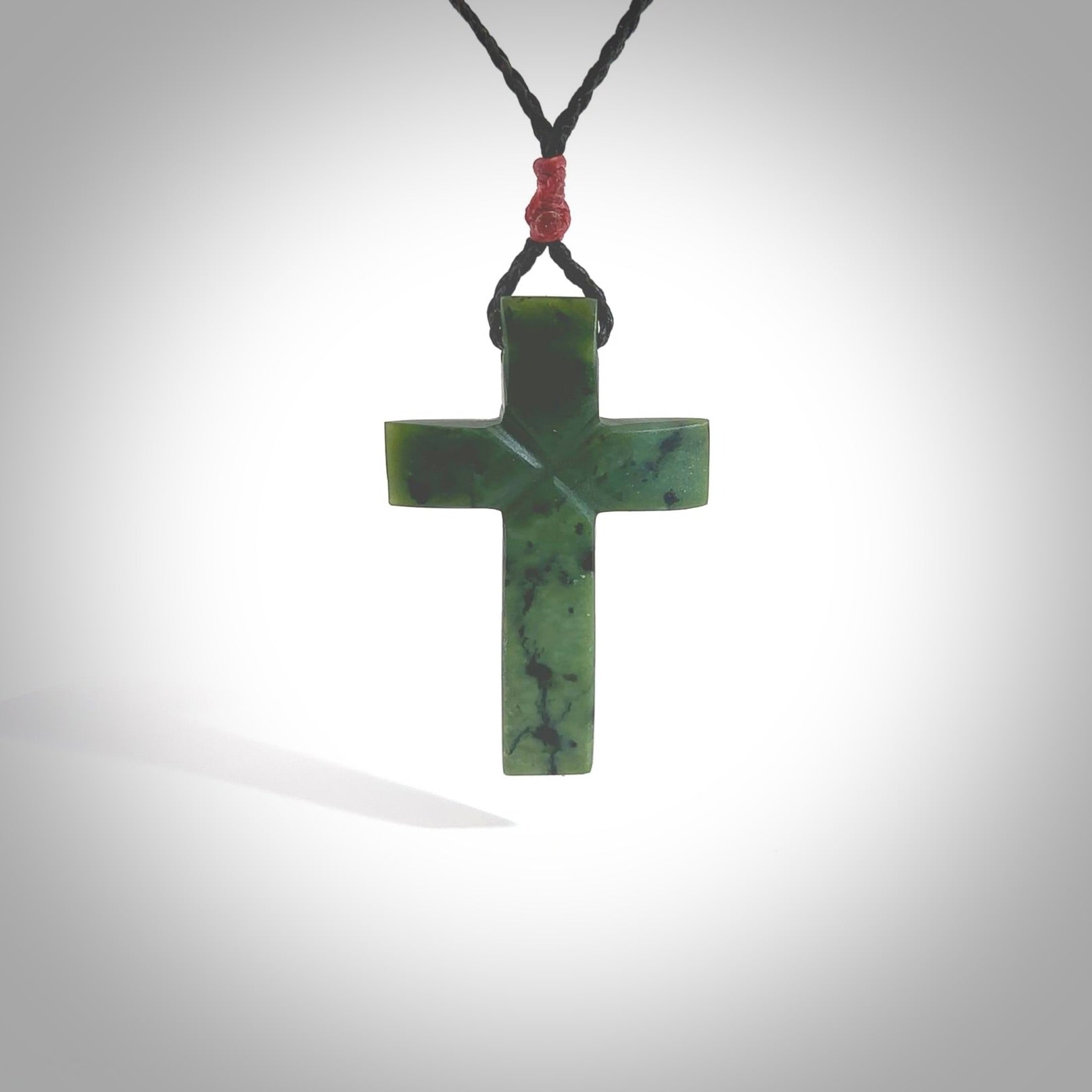 Hand carved Matte New Zealand jade cross necklace. Religious symbol pendant. Christian cross pendant for sale online. Hand crafted from New Zealand Jade Pounamu, free worldwide delivery.