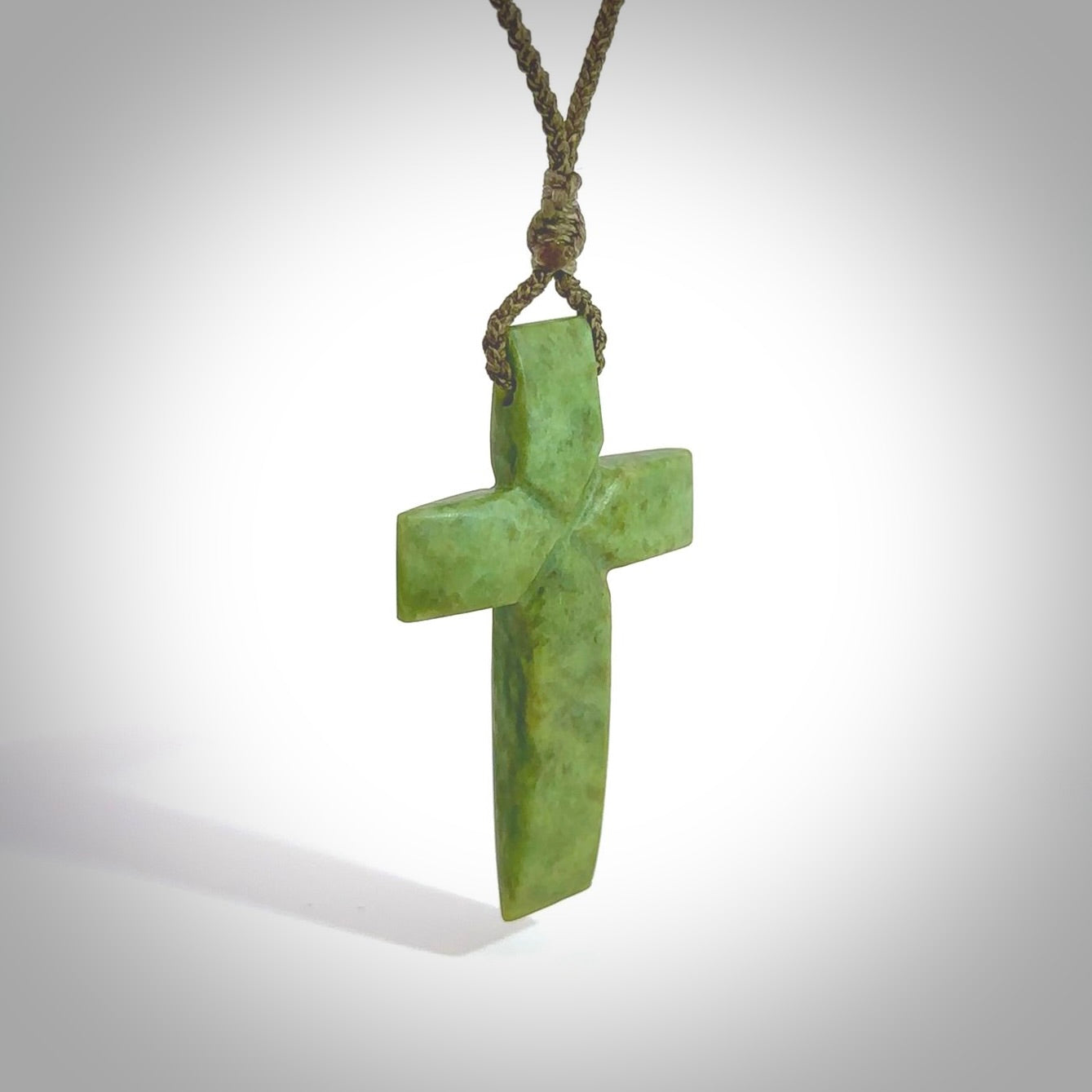 Hand carved Matte New Zealand jade cross necklace. Religious symbol pendant. Christian cross pendant for sale online. Hand crafted from New Zealand Jade Pounamu, free worldwide delivery.