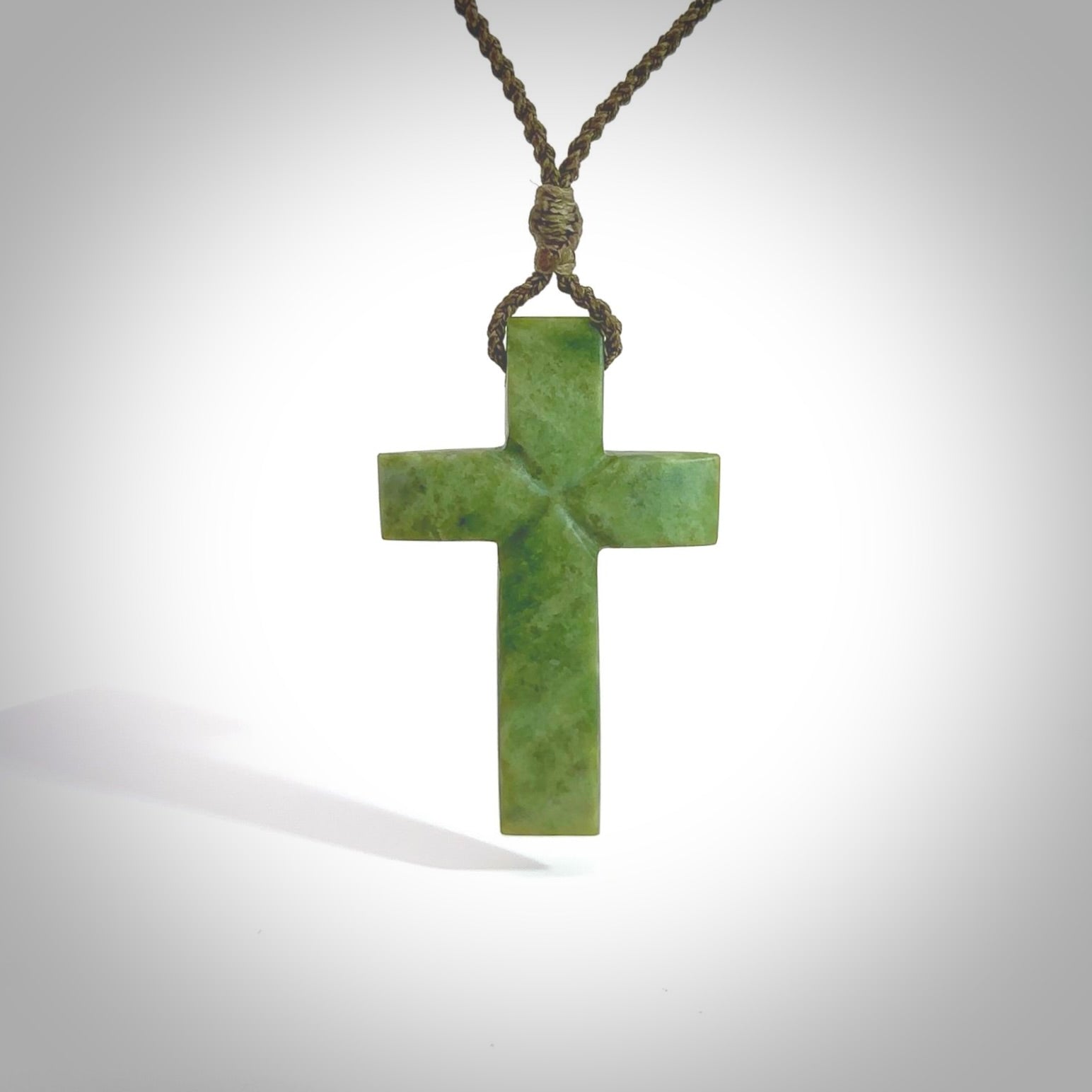 Hand carved Matte New Zealand jade cross necklace. Religious symbol pendant. Christian cross pendant for sale online. Hand crafted from New Zealand Jade Pounamu, free worldwide delivery.