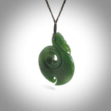 Hand carved medium sized New Zealand jade manaia with koru pendant. Made for NZ Pacific by Ross Crump. We will ship this to you with and express courier service. This is a one-off piece and is collectable. A gorgeous pendant!