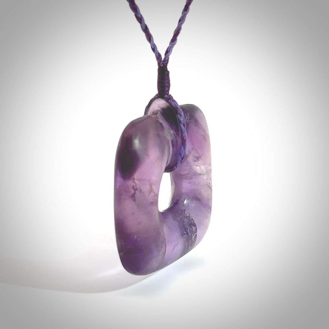 Hand carved Amethyst Crystal contemporary pendant. Carved by NZ Pacific in Amethyst Crystal. This is a modern, contemporary pendant made from natural materials.