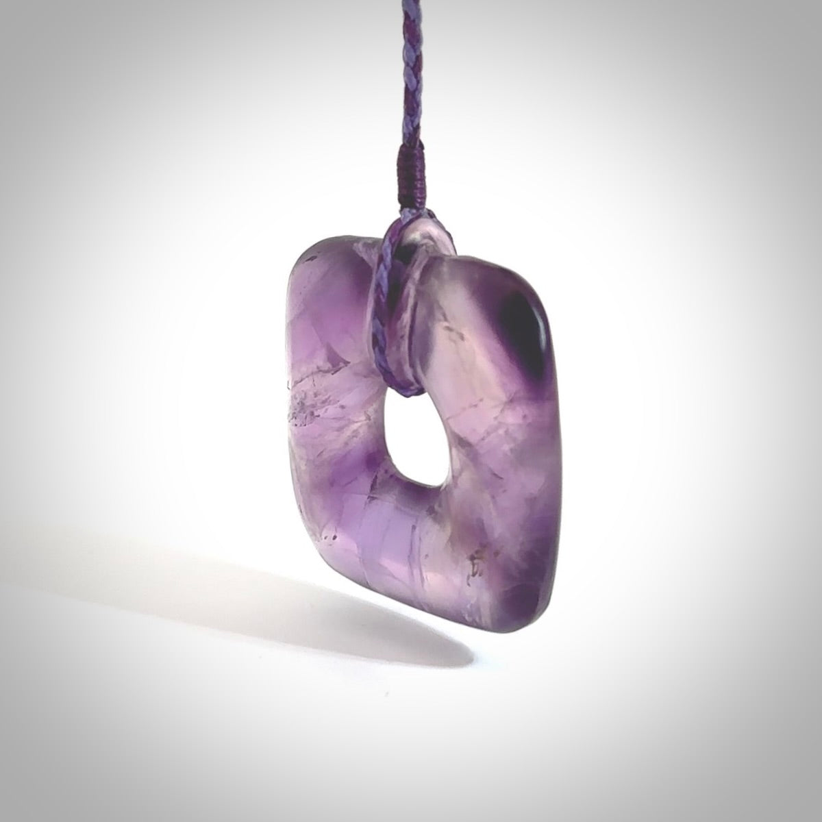 Hand carved Amethyst Crystal contemporary pendant. Carved by NZ Pacific in Amethyst Crystal. This is a modern, contemporary pendant made from natural materials.