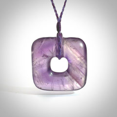 Hand carved Amethyst Crystal contemporary pendant. Carved by NZ Pacific in Amethyst Crystal. This is a modern, contemporary pendant made from natural materials.