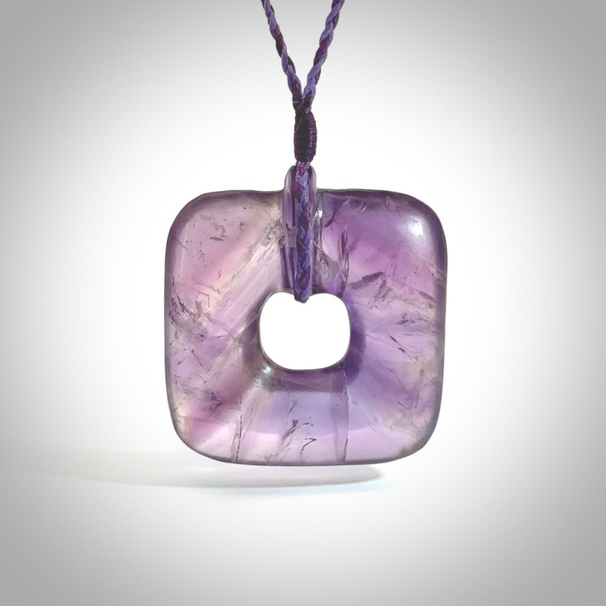 Hand carved Amethyst Crystal contemporary pendant. Carved by NZ Pacific in Amethyst Crystal. This is a modern, contemporary pendant made from natural materials.