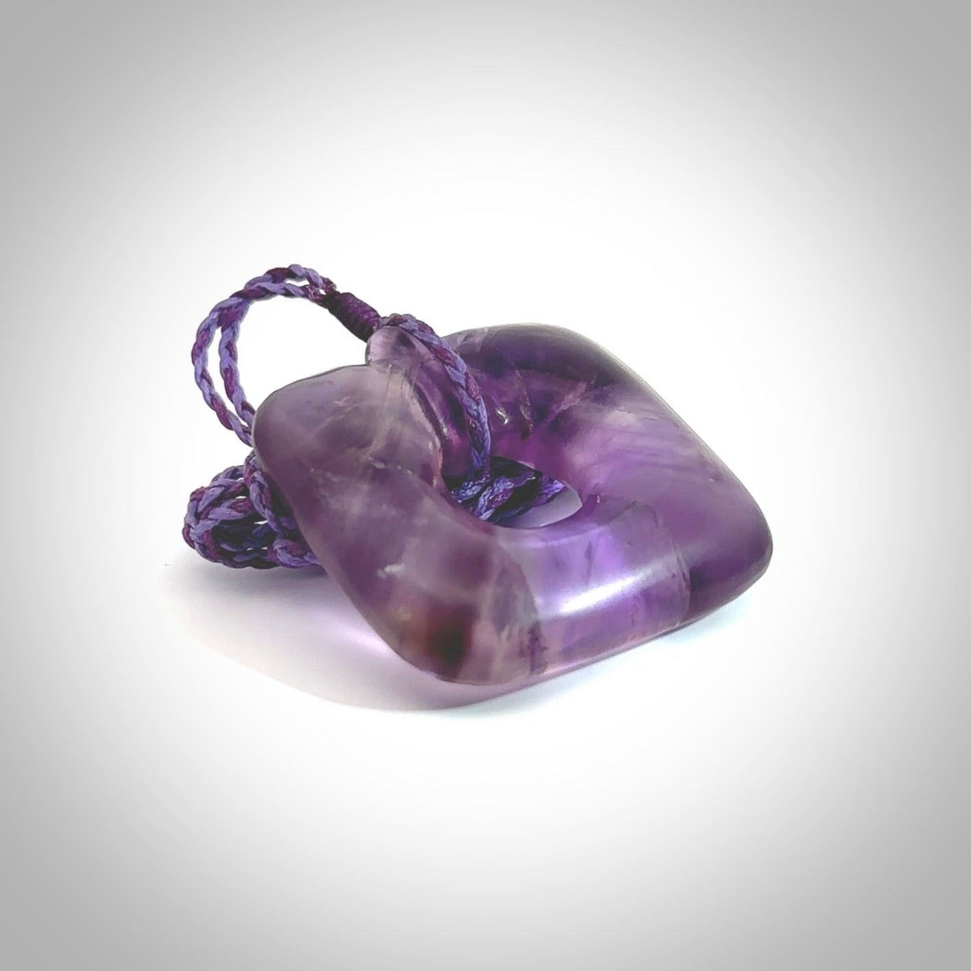 Hand carved Amethyst Crystal contemporary pendant. Carved by NZ Pacific in Amethyst Crystal. This is a modern, contemporary pendant made from natural materials.