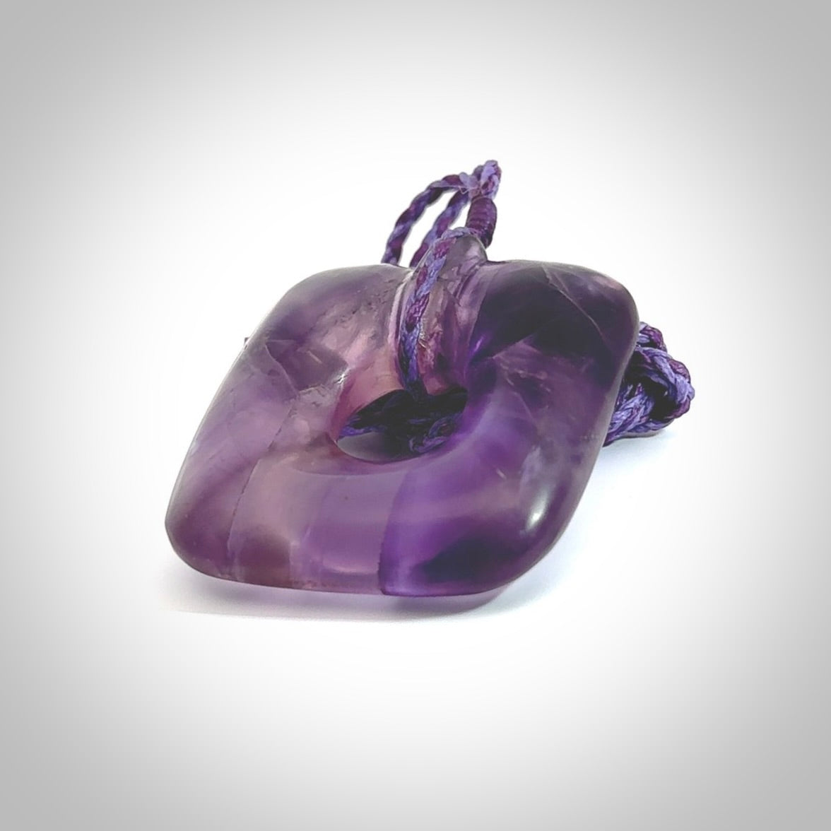 Hand carved Amethyst Crystal contemporary pendant. Carved by NZ Pacific in Amethyst Crystal. This is a modern, contemporary pendant made from natural materials.