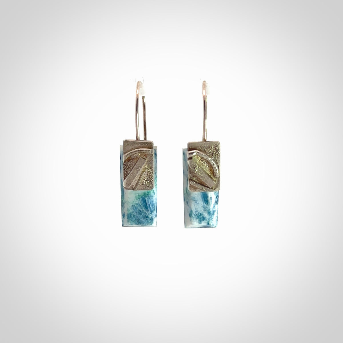 These are a pair of beautiful Aotea Stone and sterling silver earrings. It is carved from Aotea Stone from New Zealand. It is a light blue and white colour with sterling silver. Hand made here in New Zealand by Ana Krakosky.