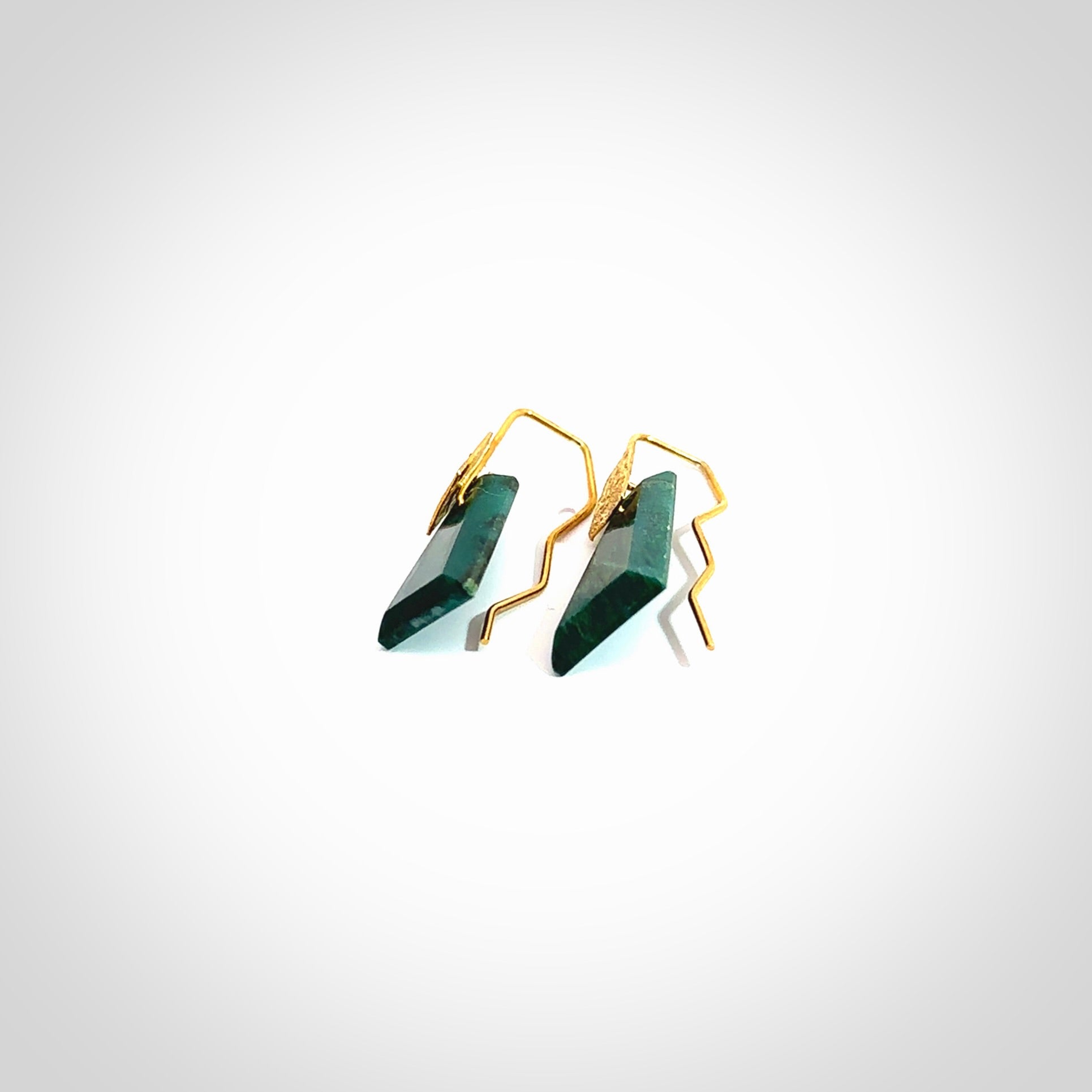 These are a pair of beautiful Goodletite Stone and gold leaf earrings. It is carved from Goodletite, ruby rock, Stone from New Zealand. It is a deep green colour with gold leaf. Hand made here in New Zealand by Ana Krakosky.