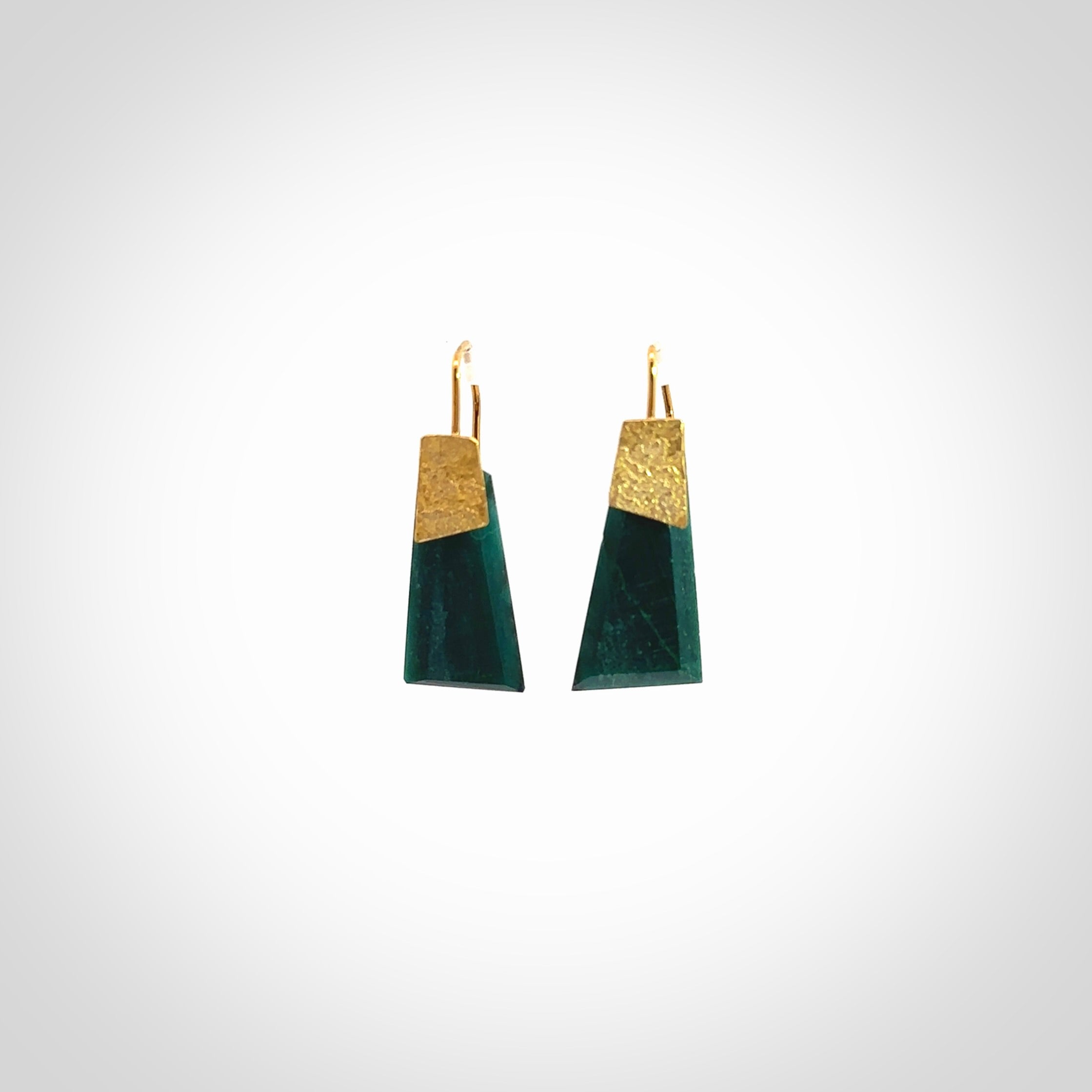 These are a pair of beautiful Goodletite Stone and gold leaf earrings. It is carved from Goodletite, ruby rock, Stone from New Zealand. It is a deep green colour with gold leaf. Hand made here in New Zealand by Ana Krakosky.