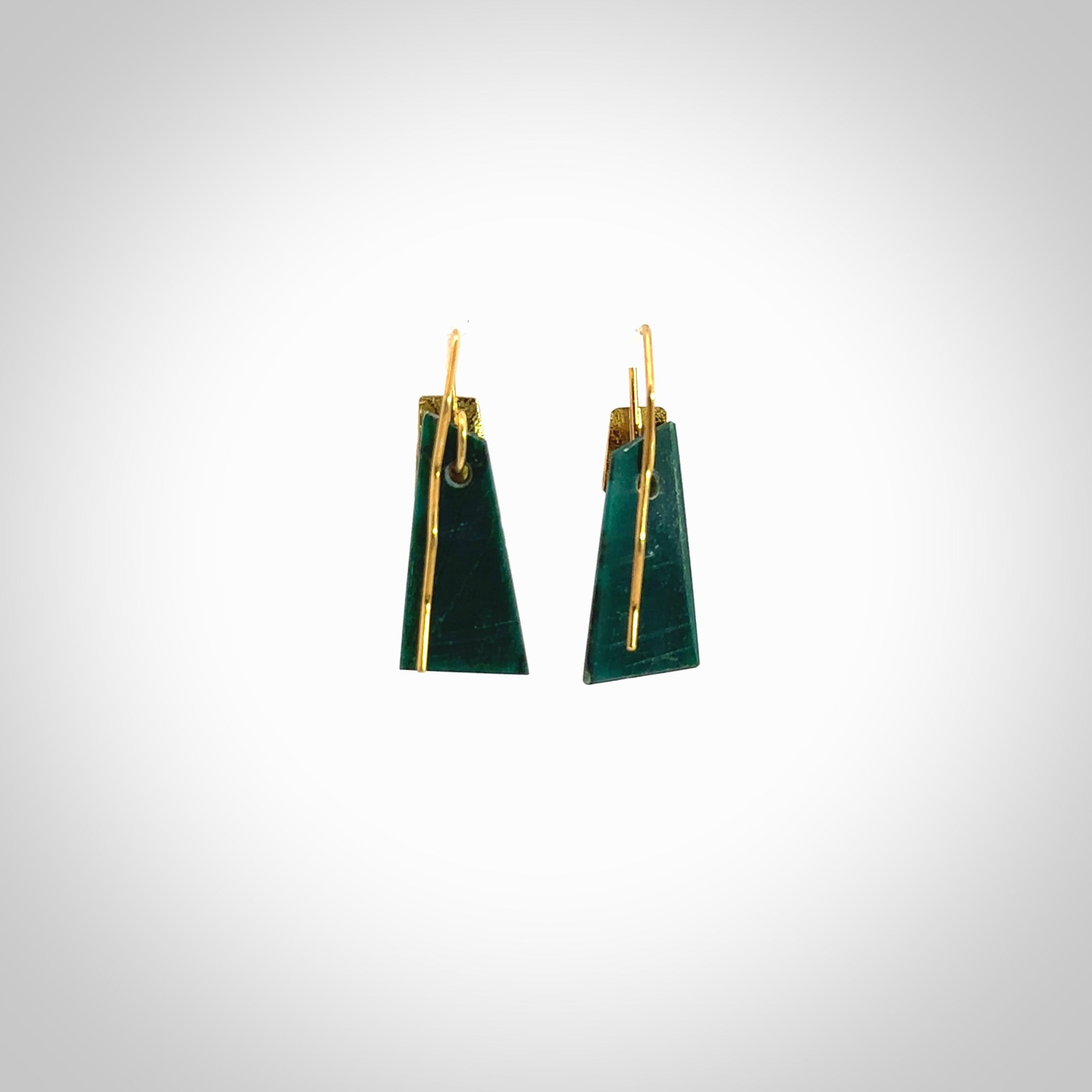 These are a pair of beautiful Goodletite Stone and gold leaf earrings. It is carved from Goodletite, ruby rock, Stone from New Zealand. It is a deep green colour with gold leaf. Hand made here in New Zealand by Ana Krakosky.