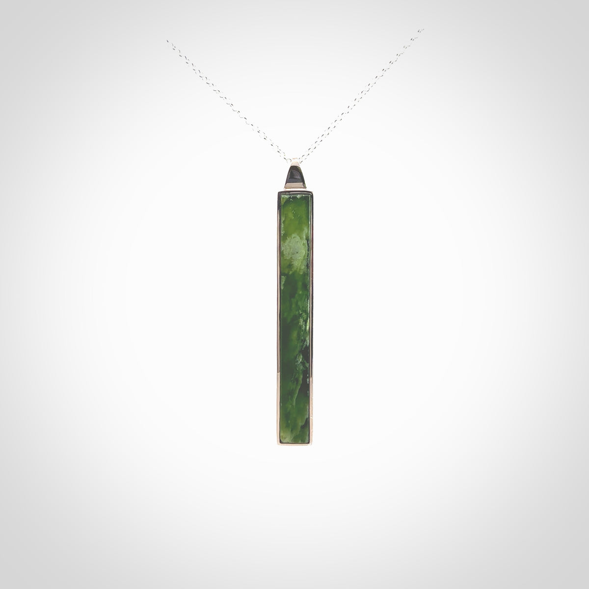 Hand carved New Zealand jade drop pendants with Sterling Silver. Contemporary drop necklaces that are hand made and will make fashionable statements around your neck. These beautiful Jade drops are in a sterling silver encasing. For sale by NZ Pacific and shipped free worldwide.