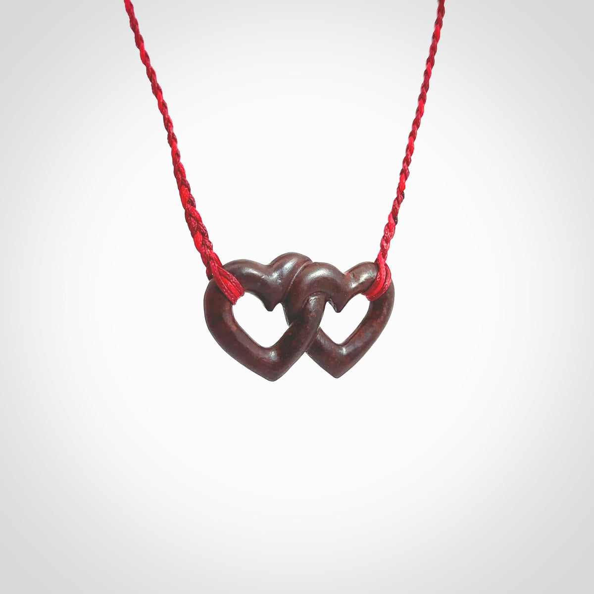 Hand carved double heart pendant made in Red jasper stone. Made by NZ Pacific. Carved from red jasper stone. Free delivery worldwide.