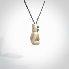 Hand carved boxing glove made from deer antler. The cord is adjustable so that you can wear this where it suits you best.