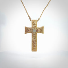 Hand carved Bone religious cross pendant by Andrew Doughty. Cross pendant with Opal inlay by Andrew Doughty with engraving in it. Beautiful unisex necklace hand carved in New Zealand, delivered in a woven kete pouch. Provided with an adjustable beige cord.