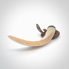 Hand carved Boars Tusk pendant with Buffalo horn, Mother of Pearl and Brass. Engraved large boars tusk pendant. Unisex necklace hand carved by Andrew Doughty here in New Zealand. Unique art to wear. Delivered with an adjustable brown cord.