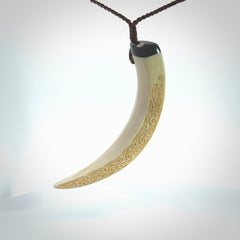 Hand carved Boars Tusk pendant with Buffalo horn, Mother of Pearl and Brass. Engraved large boars tusk pendant. Unisex necklace hand carved by Andrew Doughty here in New Zealand. Unique art to wear. Delivered with an adjustable brown cord.