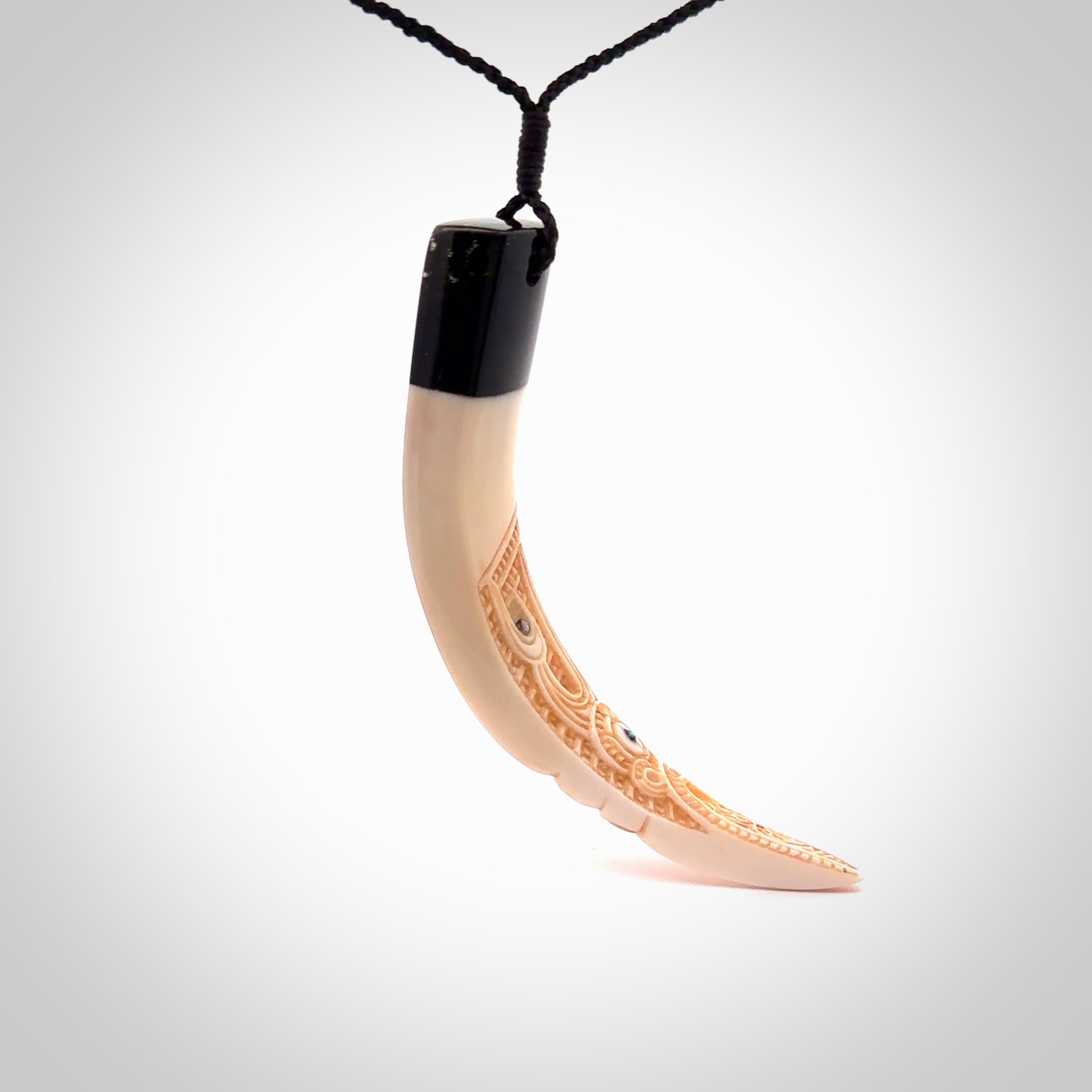 Hand carved Boars Tusk pendant with Buffalo horn and Paua Shell. Engraved large boars tusk pendant. Unisex necklace hand carved by Andrew Doughty here in New Zealand. Unique art to wear. Delivered with an adjustable black cord.