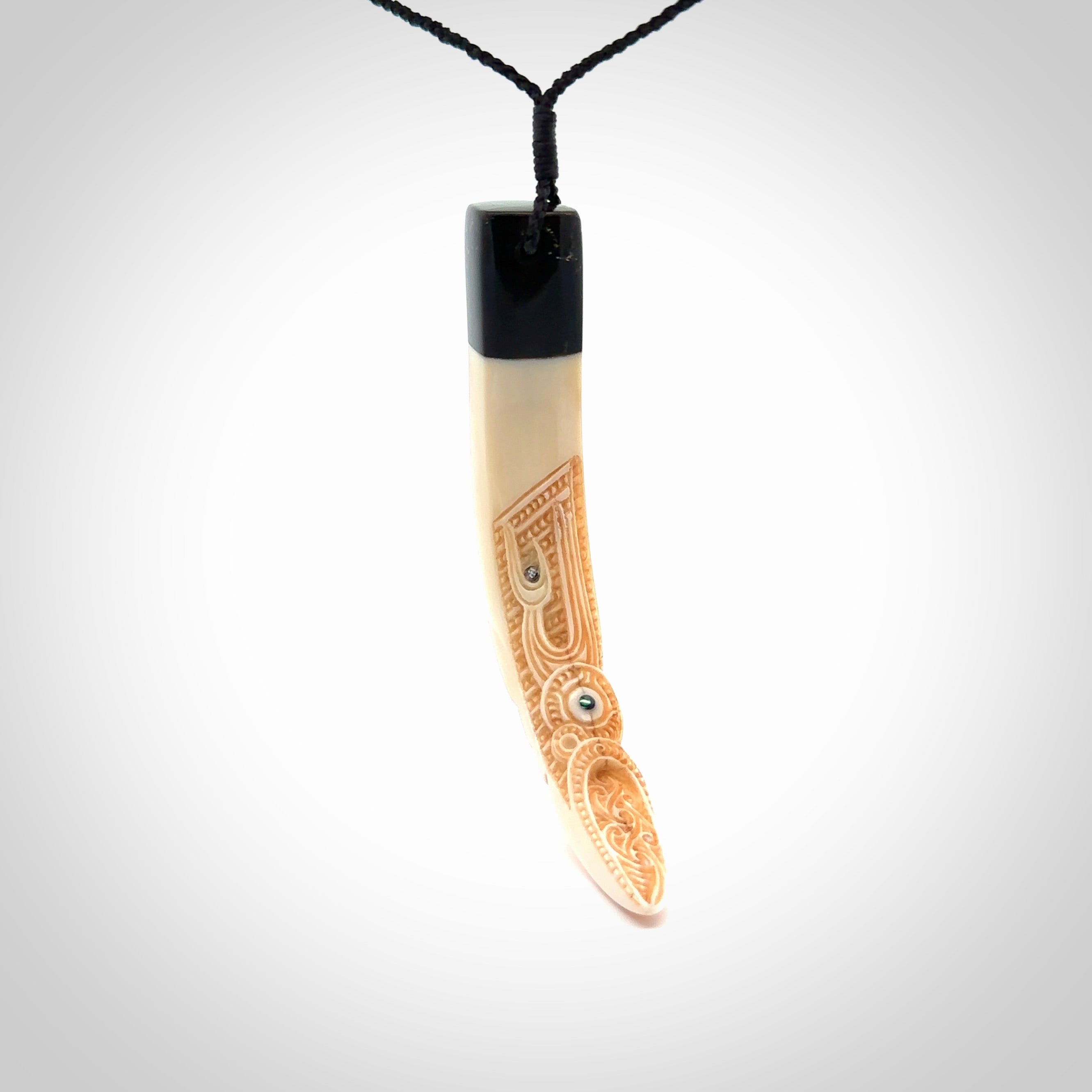 Hand carved Boars Tusk pendant with Buffalo horn and Paua Shell. Engraved large boars tusk pendant. Unisex necklace hand carved by Andrew Doughty here in New Zealand. Unique art to wear. Delivered with an adjustable black cord.