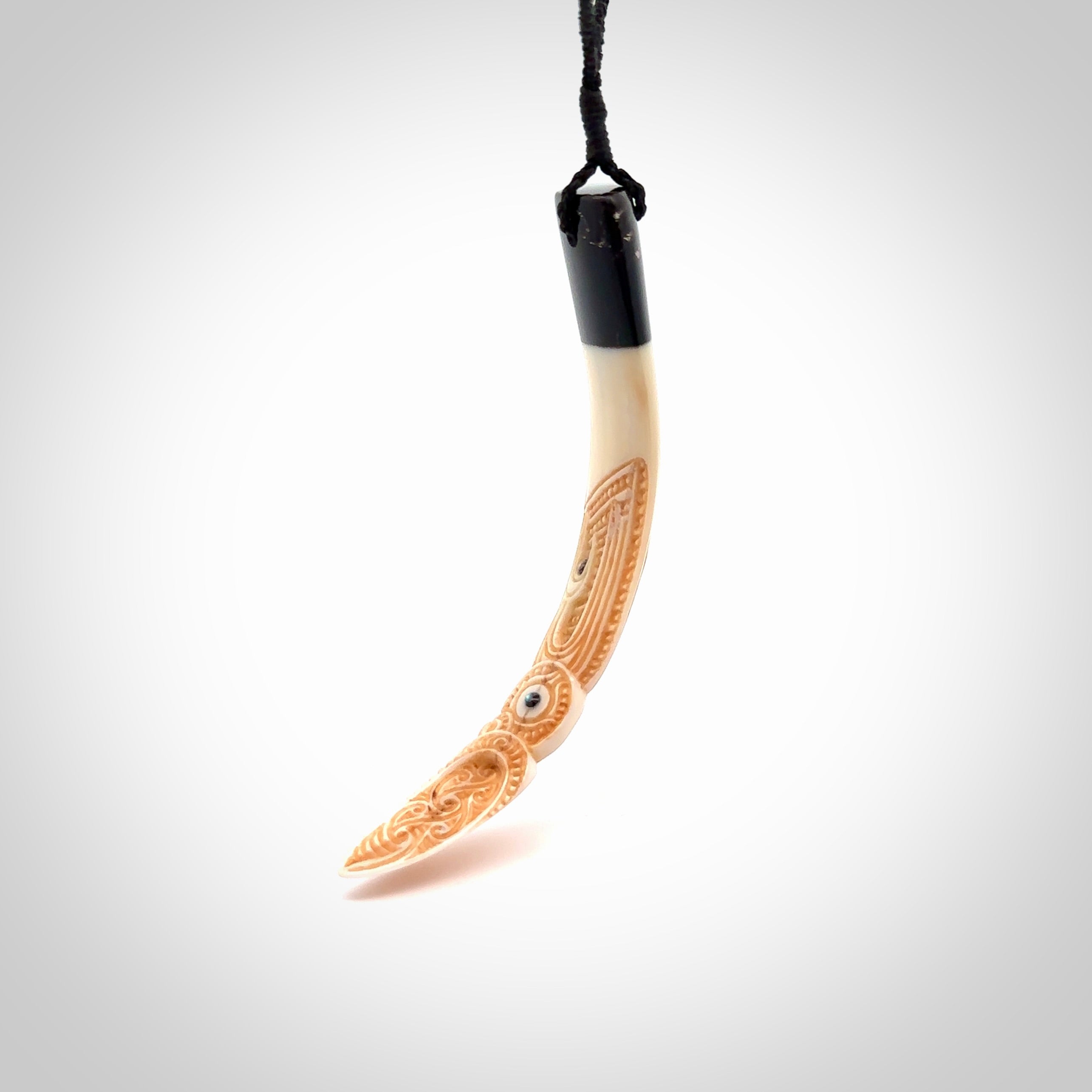 Hand carved Boars Tusk pendant with Buffalo horn and Paua Shell. Engraved large boars tusk pendant. Unisex necklace hand carved by Andrew Doughty here in New Zealand. Unique art to wear. Delivered with an adjustable black cord.